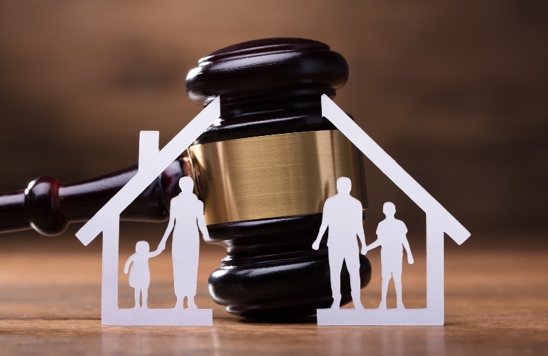 white paper family model divided in half by a judge's gavel