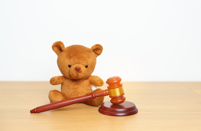 teddy bear and judge gavel on white background